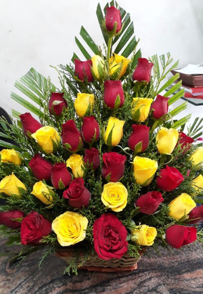 Red Colour Roses and Yellow Colour Roses with Green Leaves Basket Arrangement