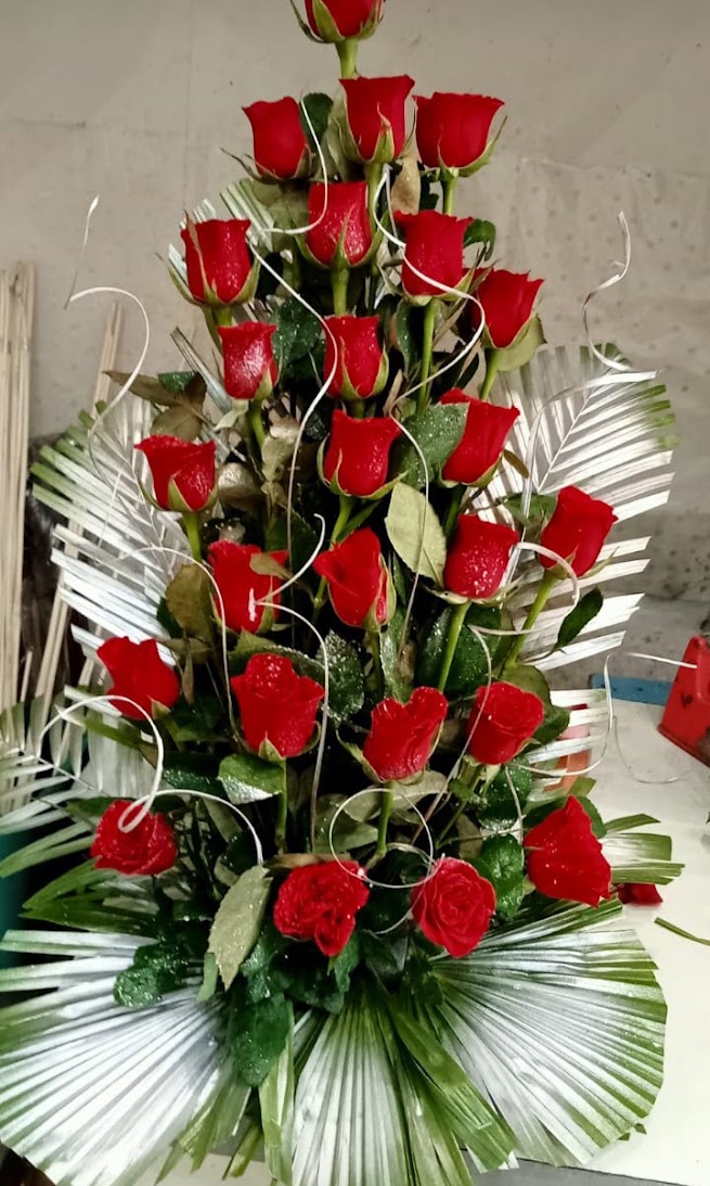 Premium Red Colour Roses with Decorative Green Leaves Vertical Arrangement