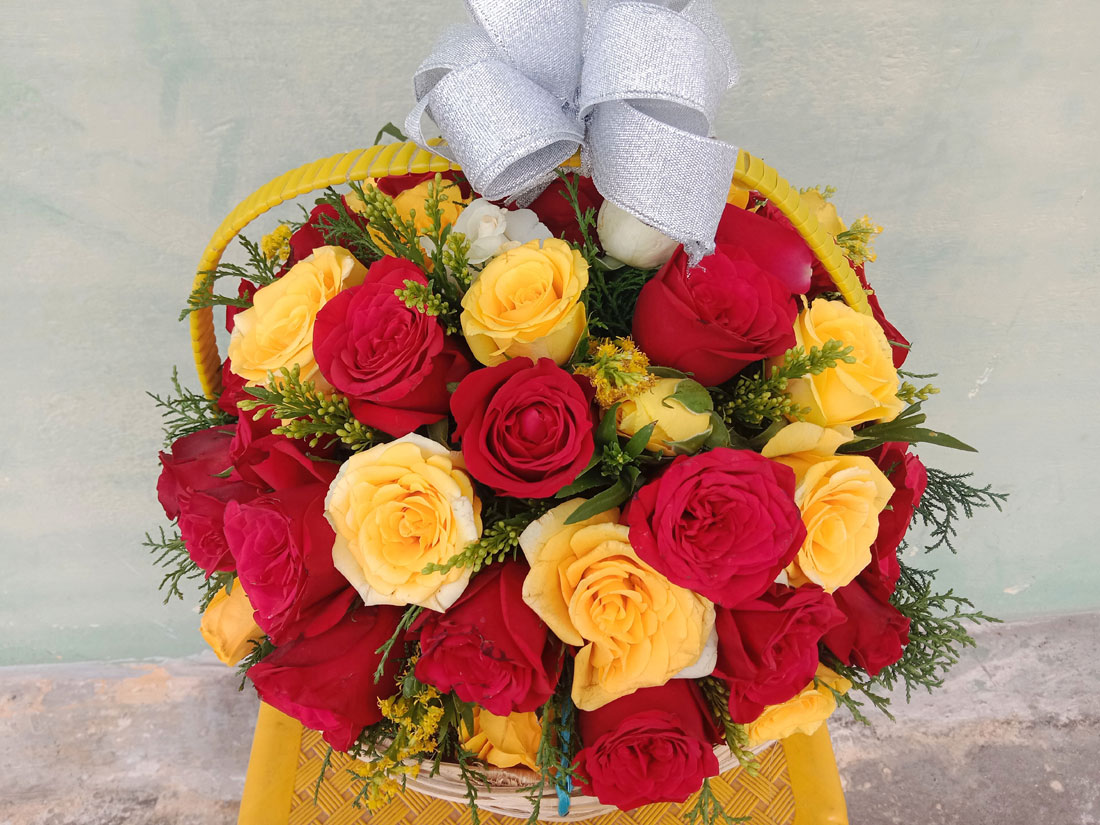 Lovely Red and Yellow Roses Basket Arrangement with Green Fillers